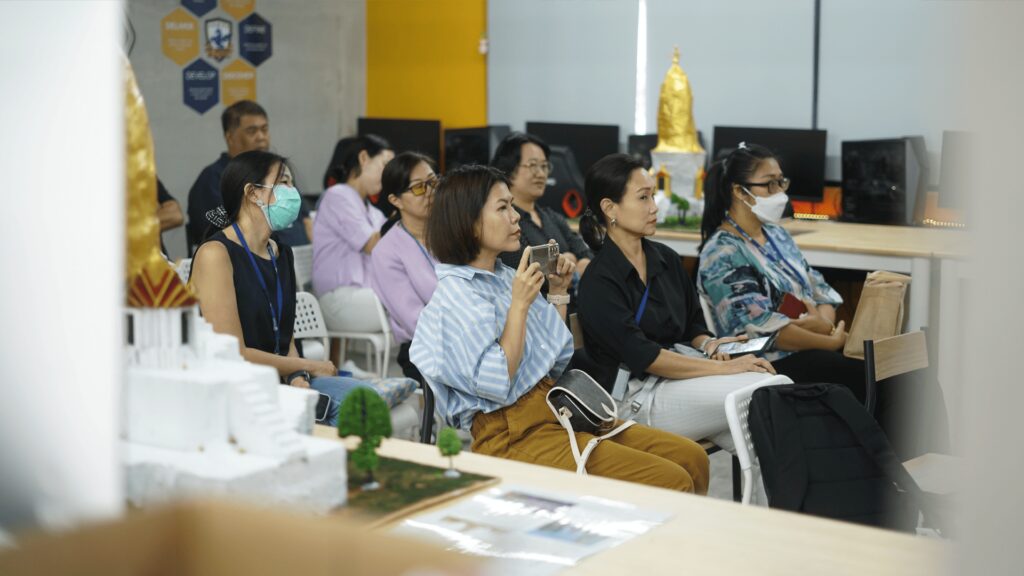 Middle School parents listening to their children's presentation in D-Lab