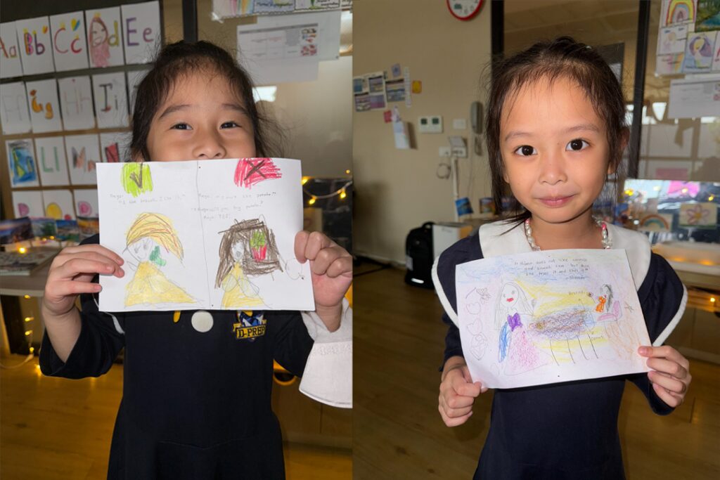 Early Years students showing their drawings
