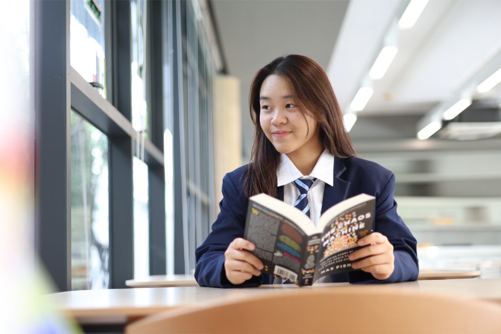Grade 10 student. Prim, reading a book