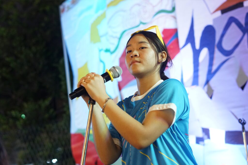 Prim singing in front of the D-PREP community during Open World Thailand